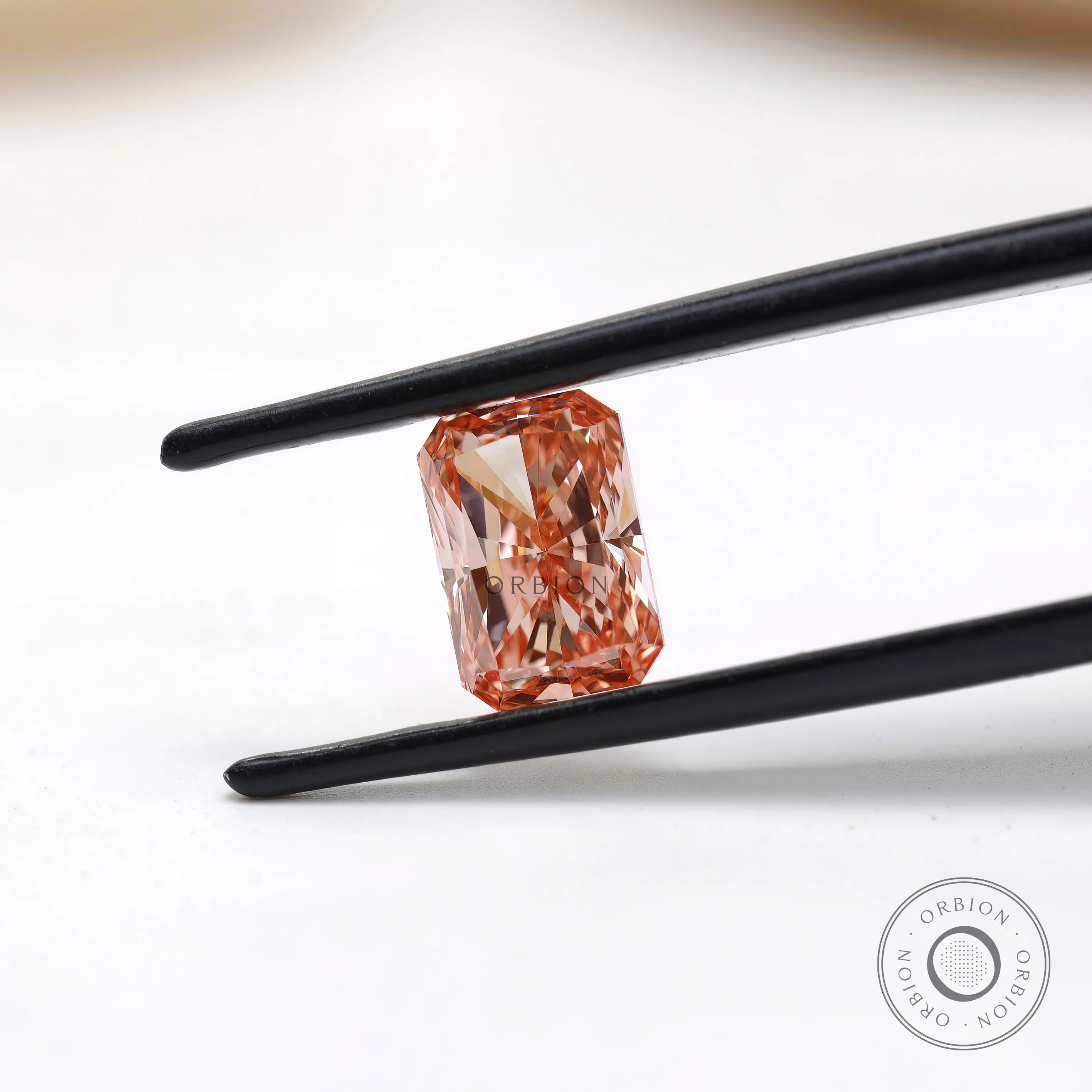Angled close view of fancy pink radiant lab diamond