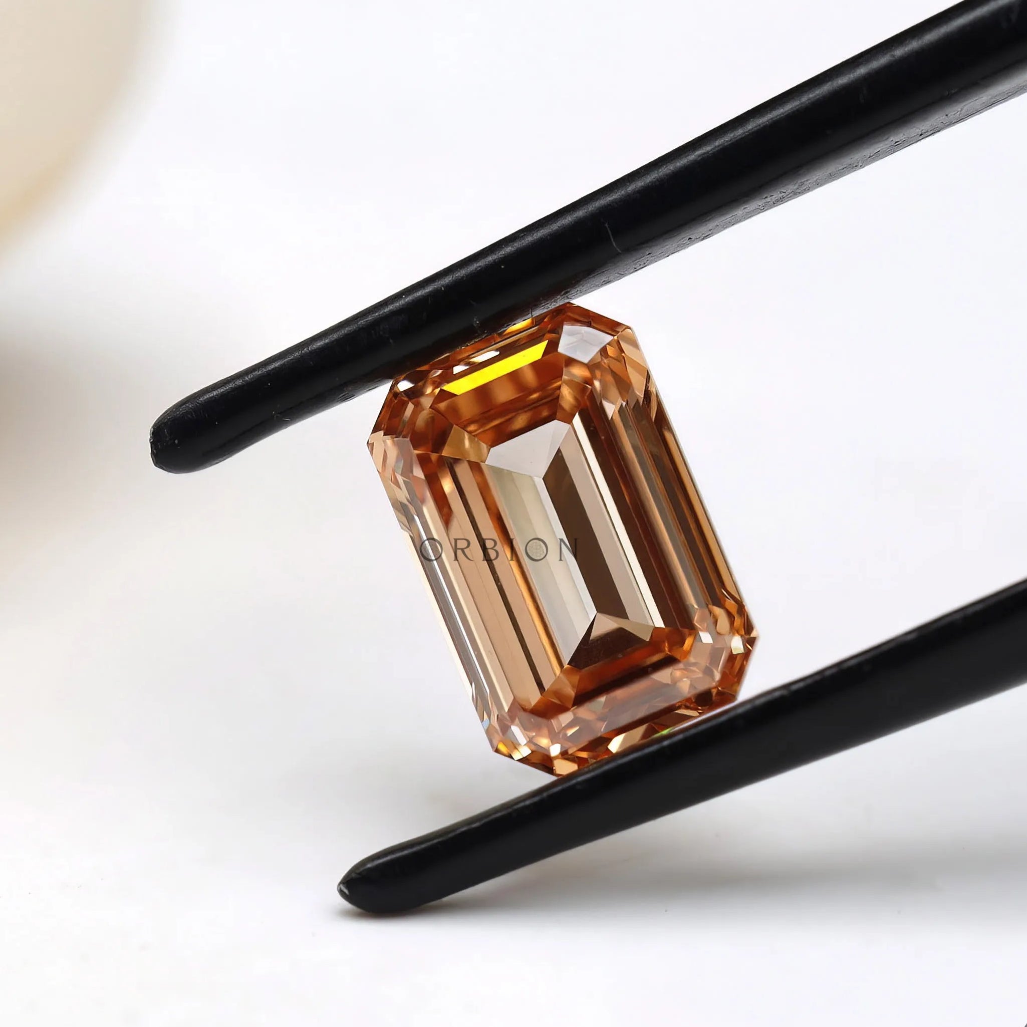 Angled view of orange emerald cut loose lab diamond
