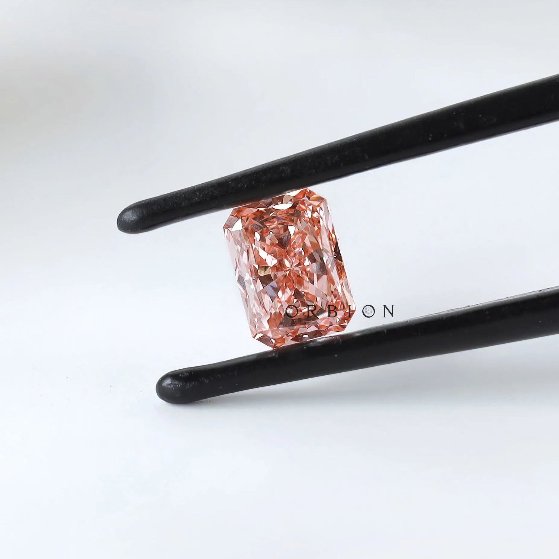 Angled view of matched pink radiant diamond pair