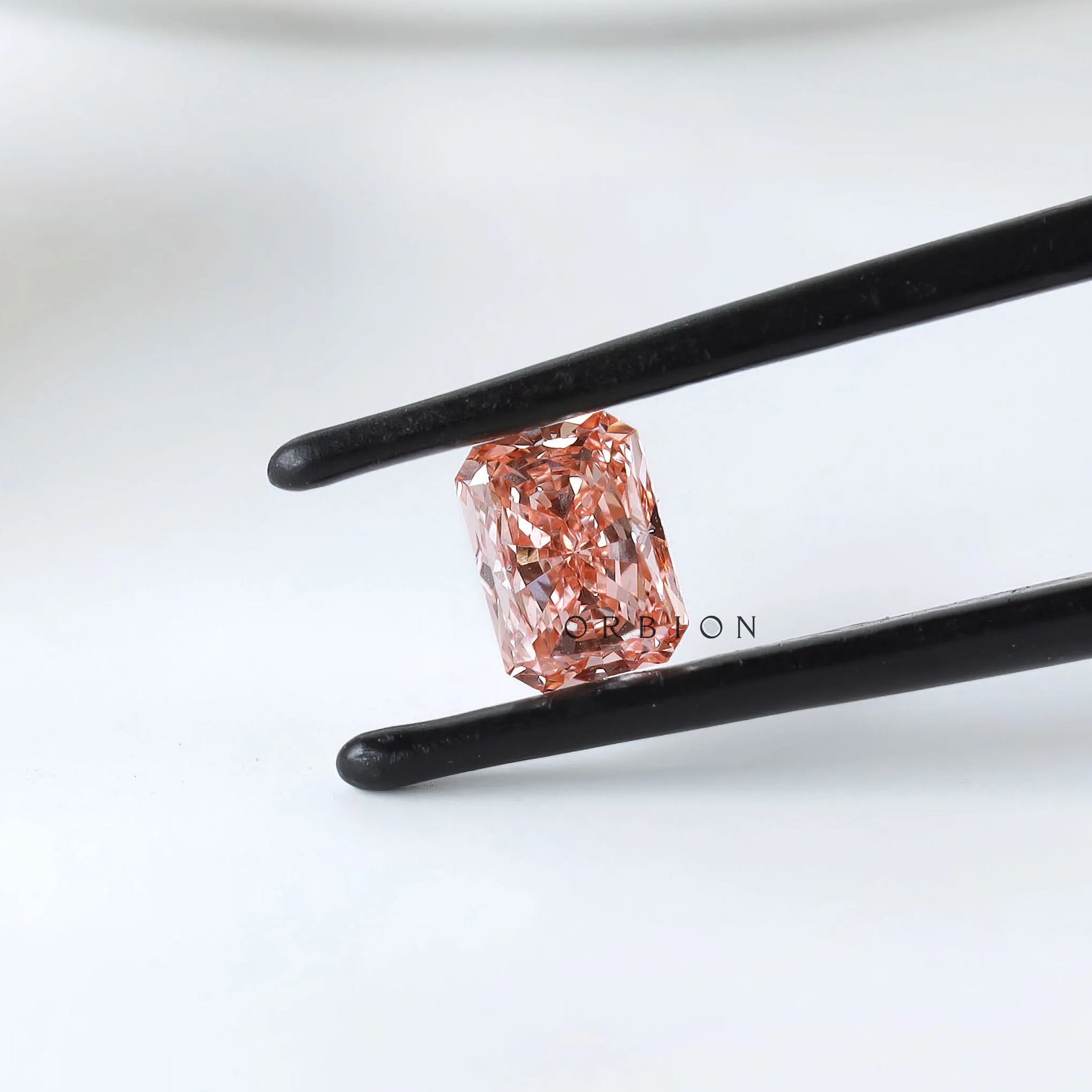 Angled view of matched pink radiant diamond pair