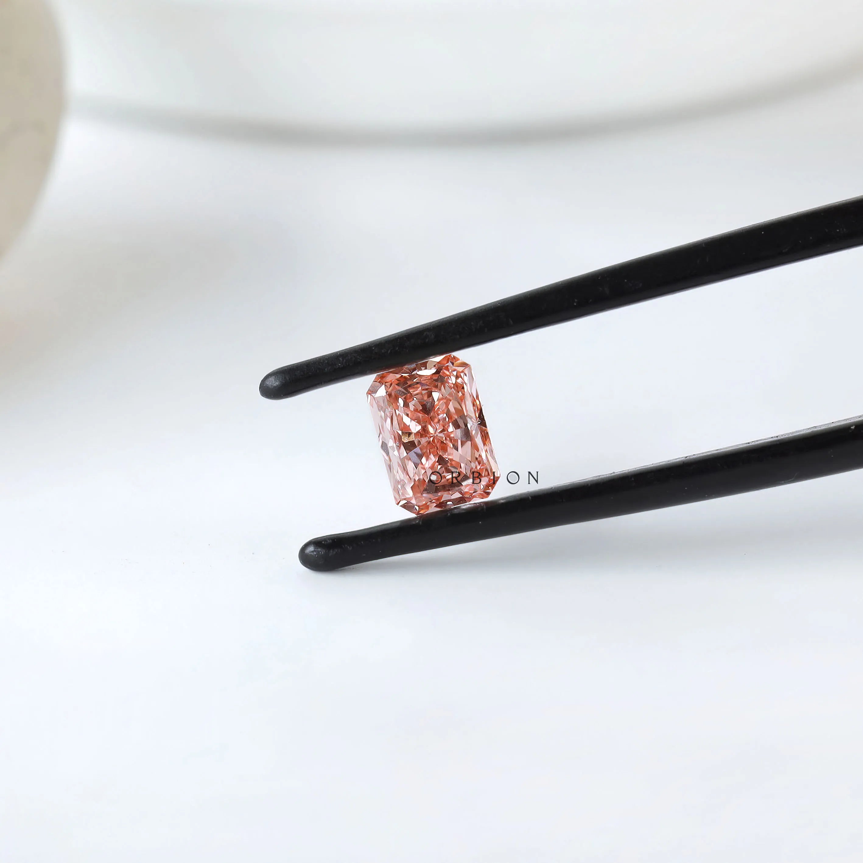 Angled view of matched pink radiant diamond pair