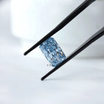Angled view radiant blue loose lab diamond in tweezers