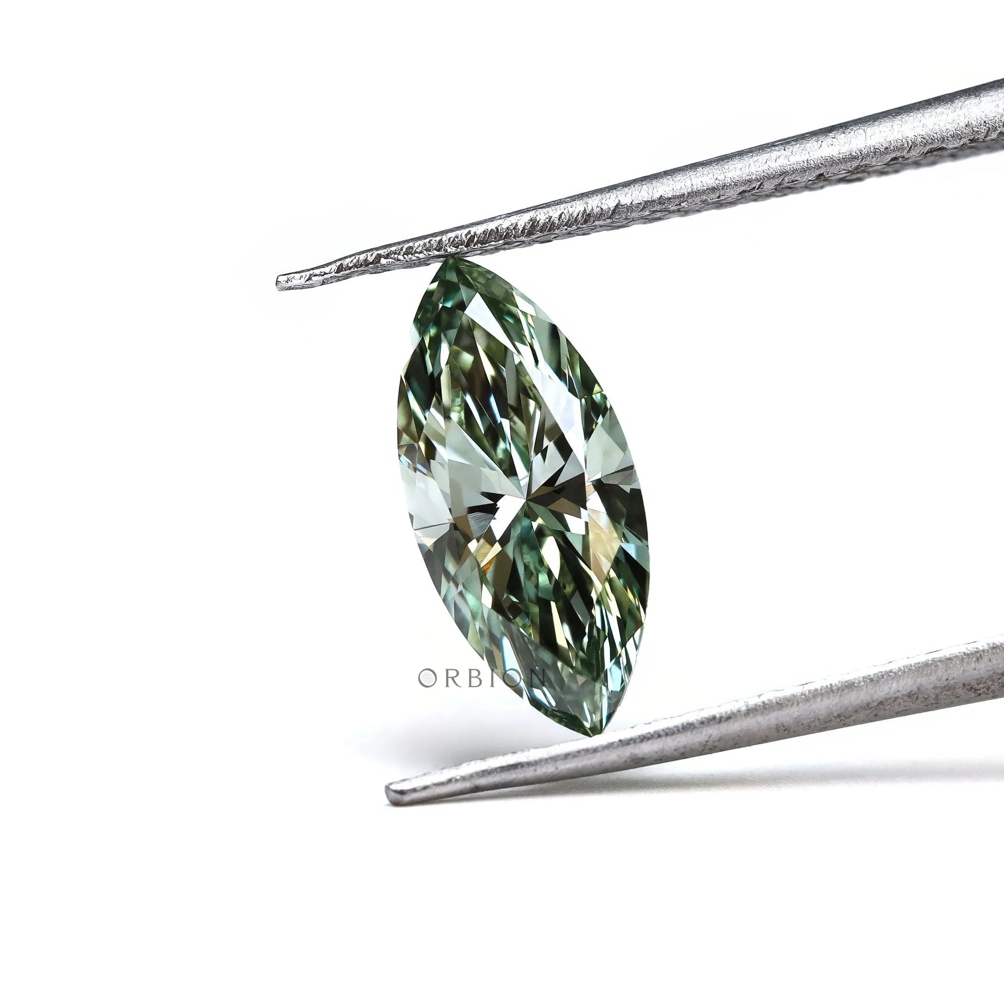 Loose green marquise brilliant cut diamond angled in tweezers
