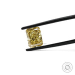 Fancy yellow radiant lab diamond held in black tweezers close-up