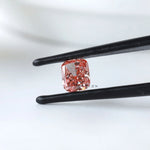 Cushion modified brilliant vivid pink lab diamond angled in tweezers