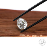 Loose pear lab diamond in tweezers with bright sparkle
