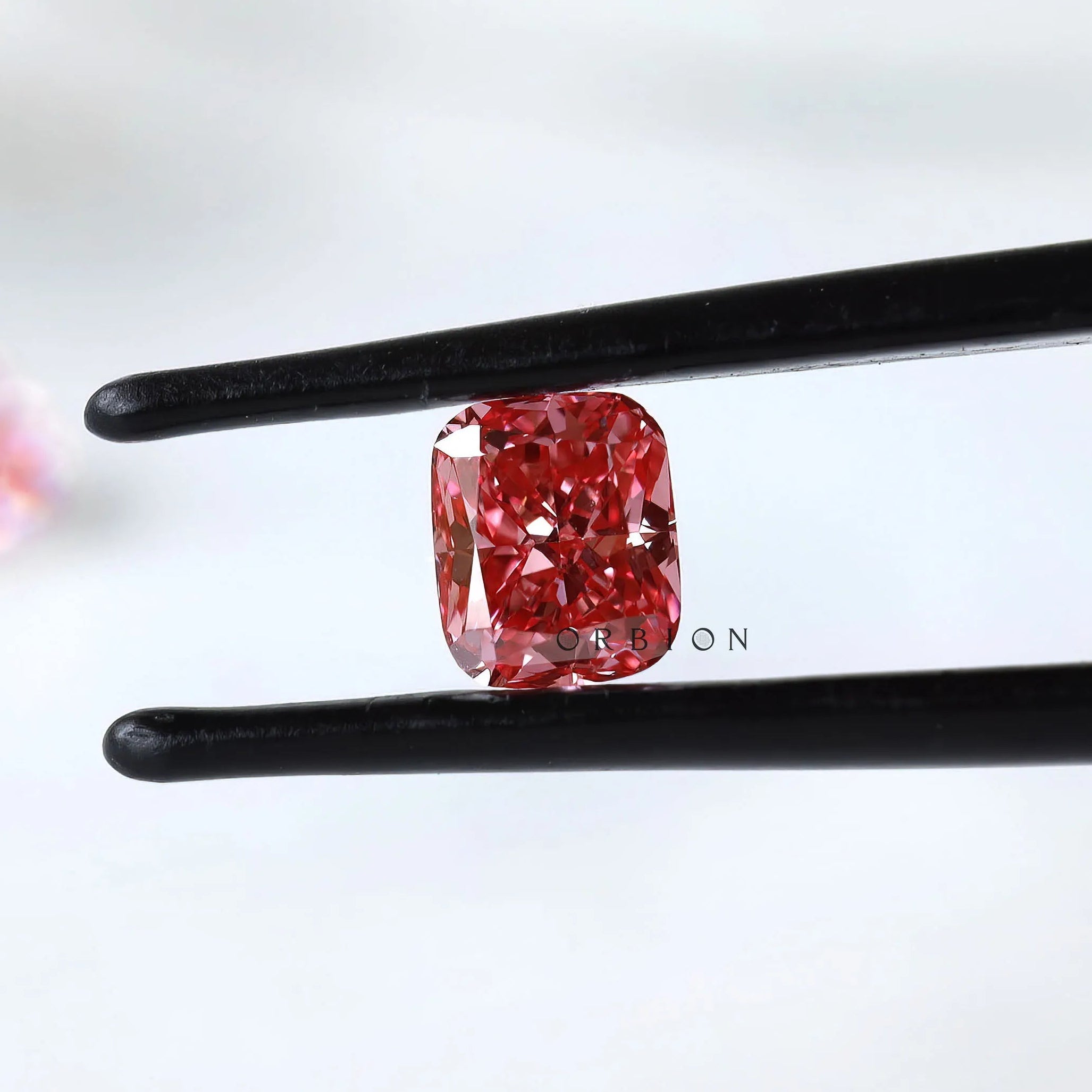 Matching vivid pink cushion loose lab diamonds close-up view
