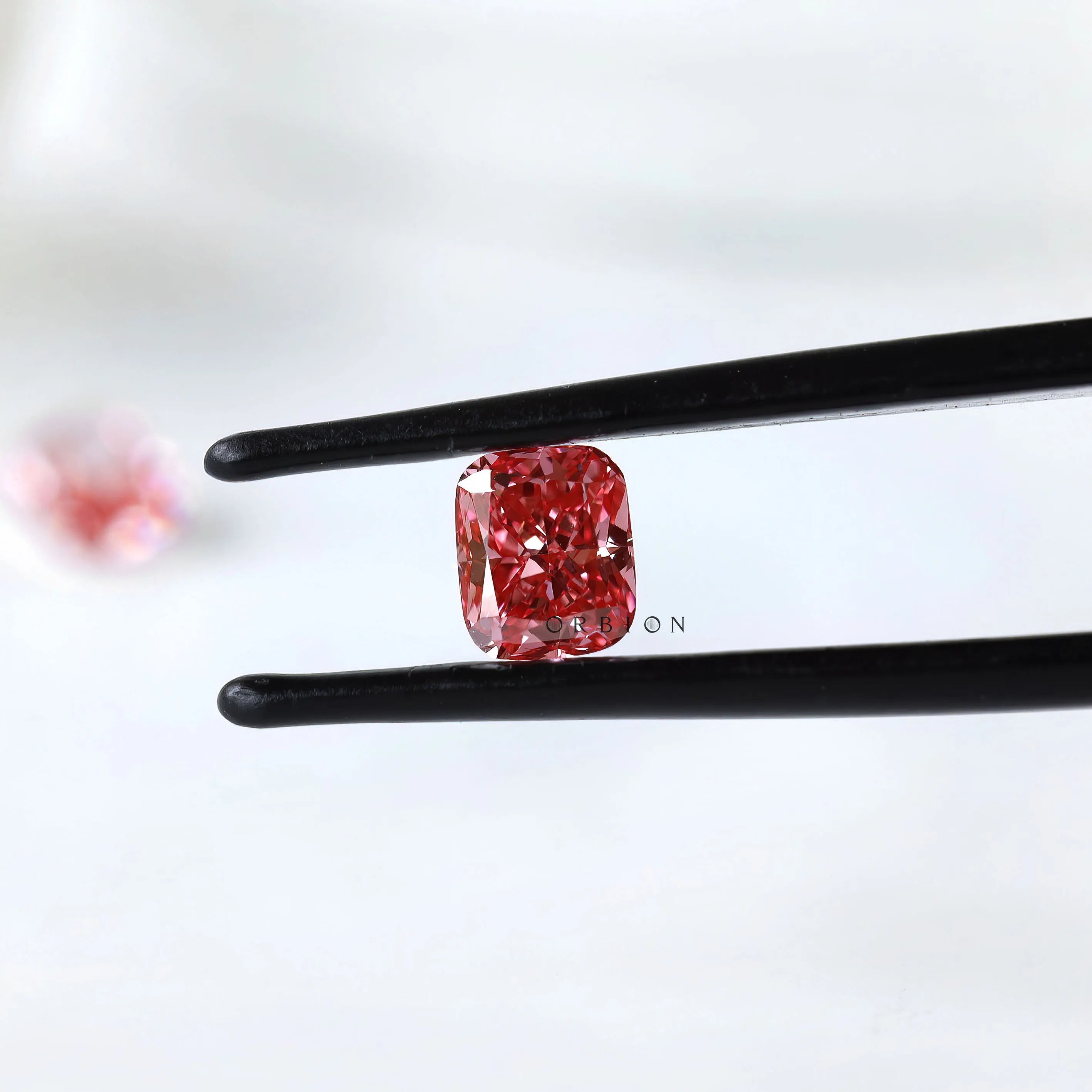 Matching vivid pink cushion loose lab diamonds close-up view