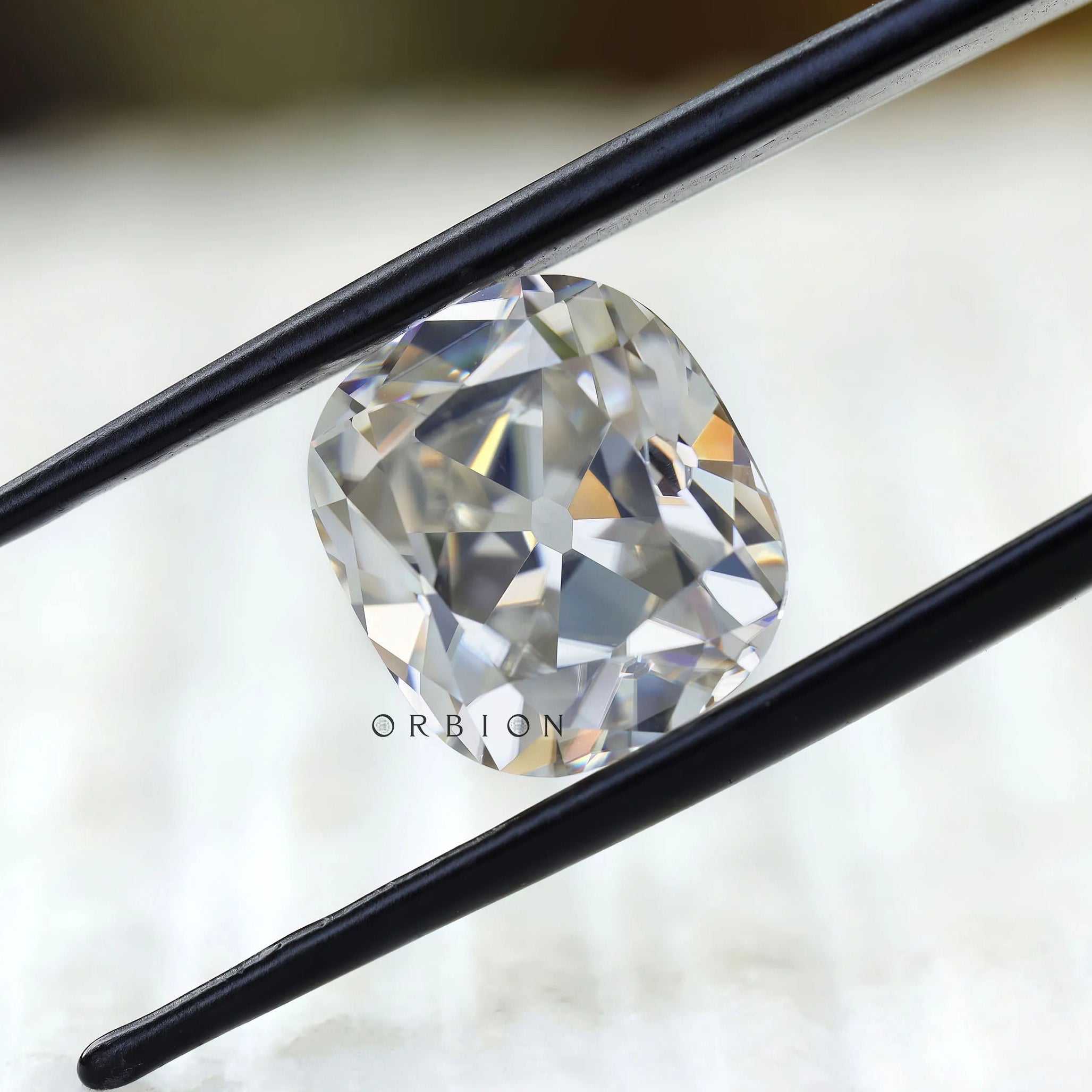 Loose cushion moissanite showing antique facet reflections