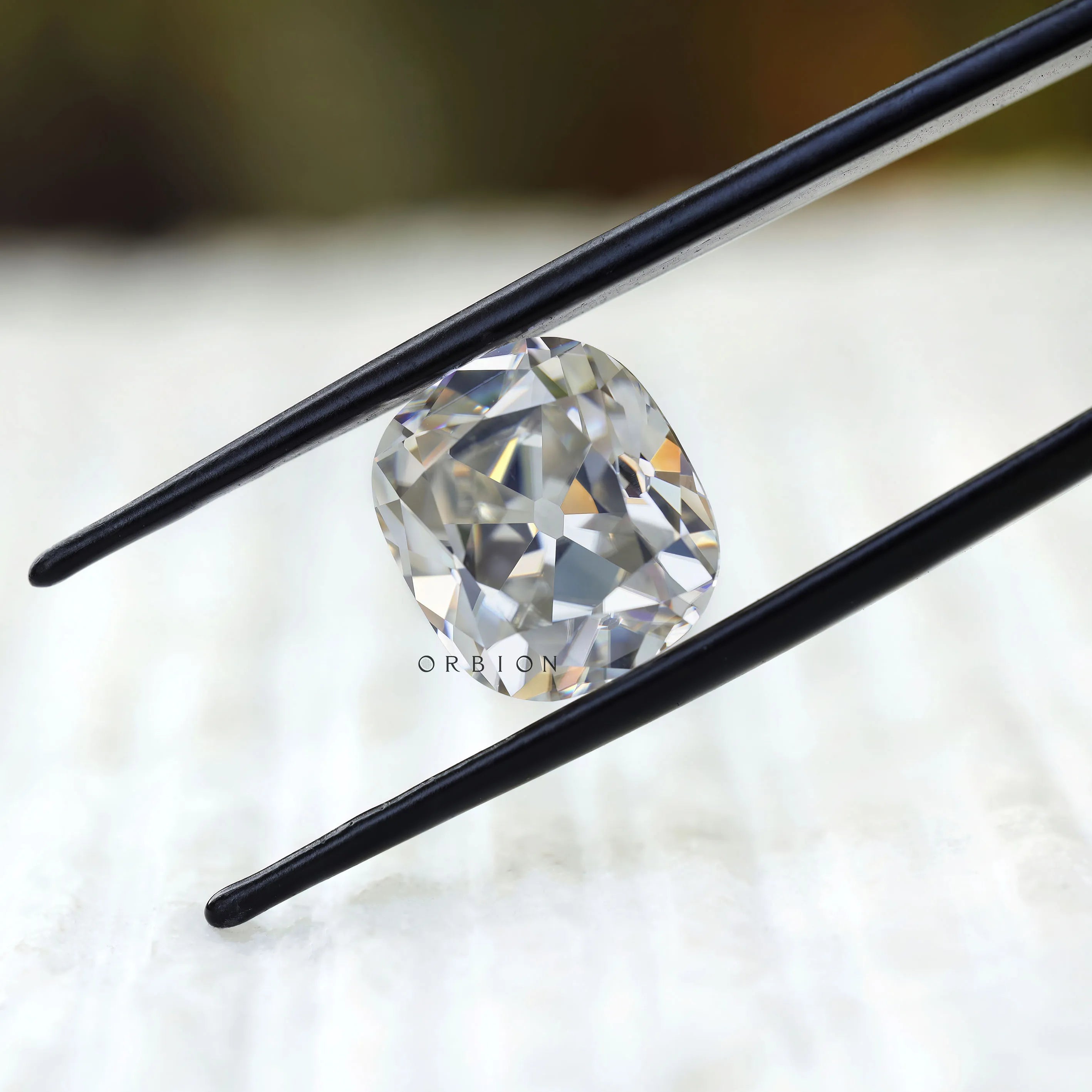 Loose cushion moissanite showing antique facet reflections