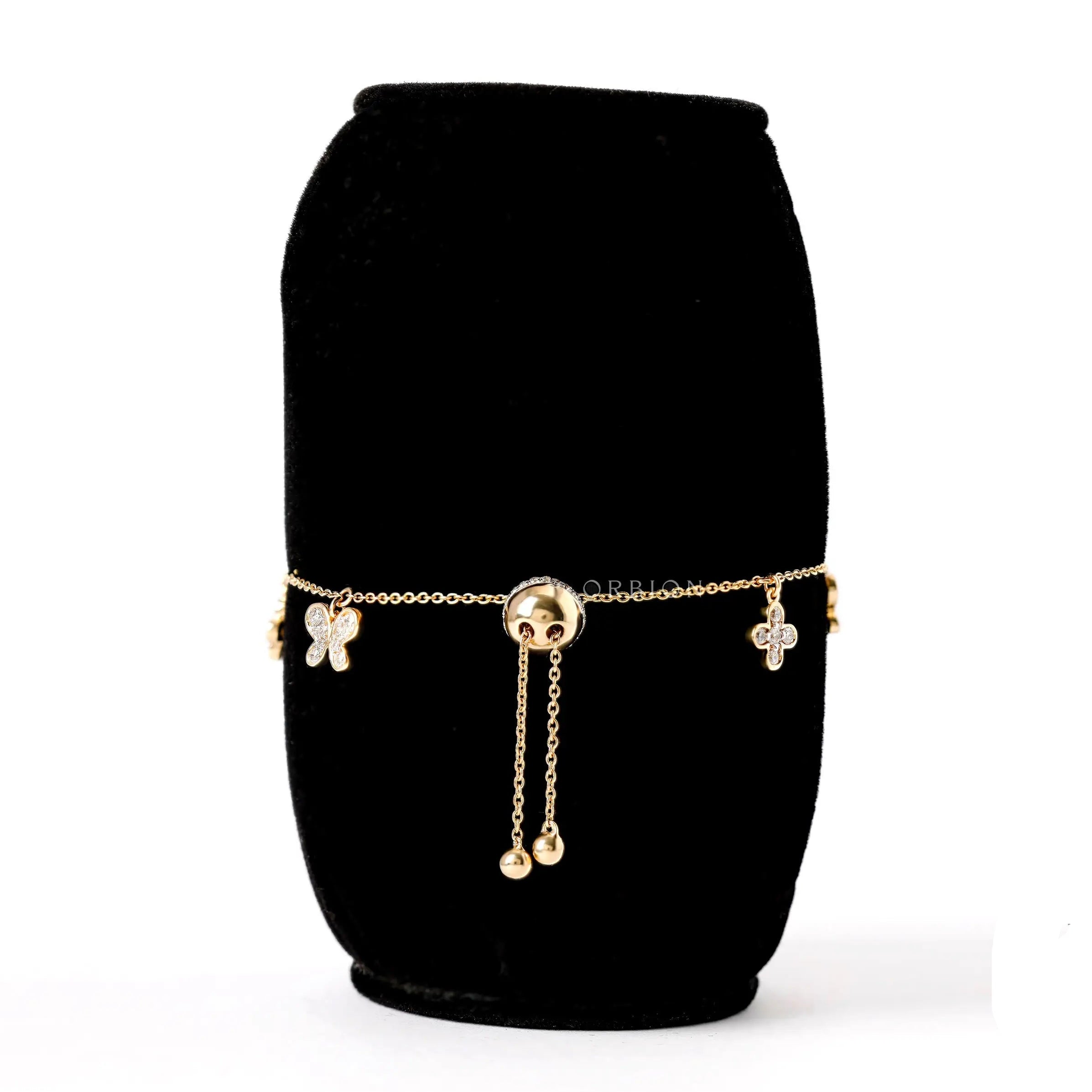 Back view adjustable bolo bracelet with butterfly and clover charms