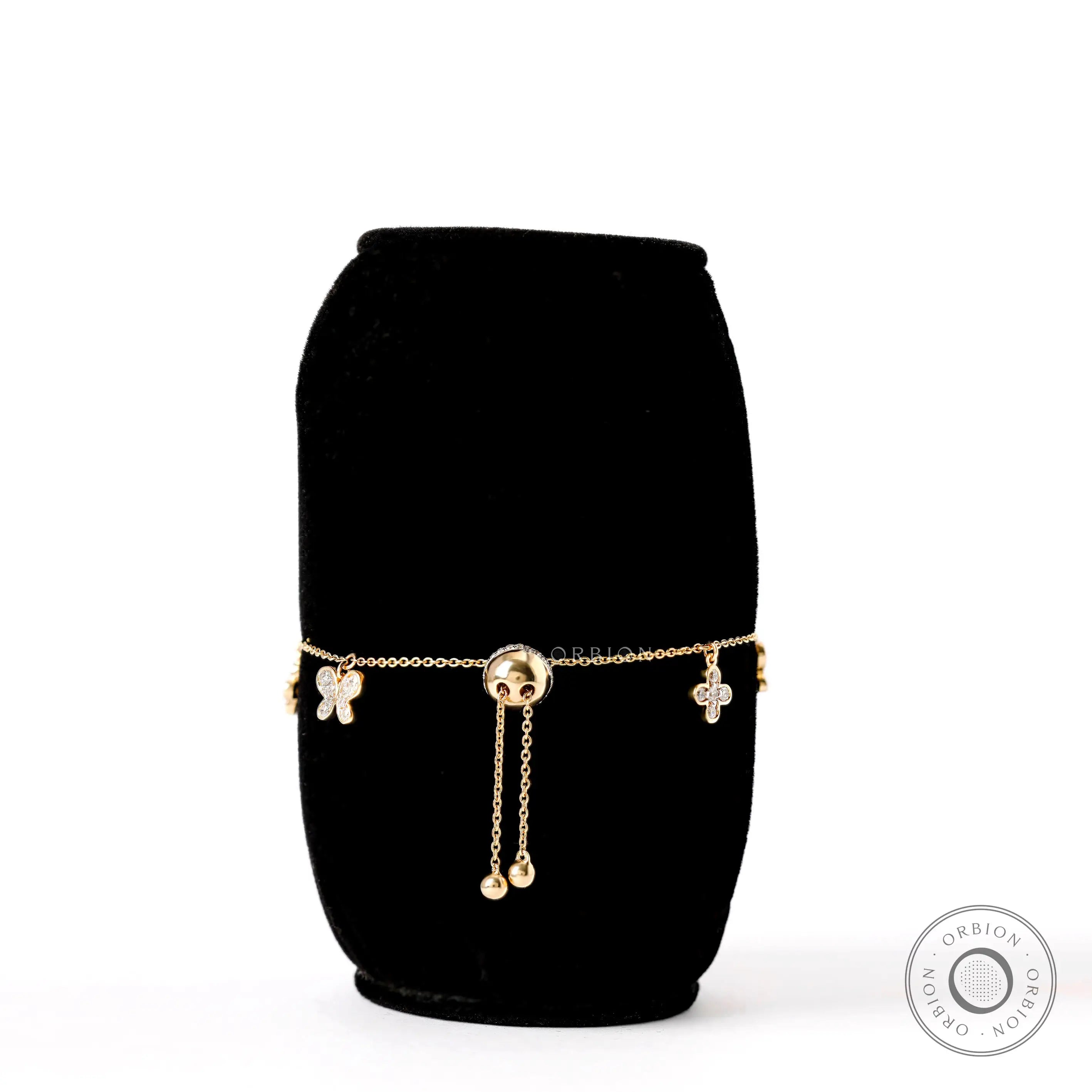 Back view adjustable bolo bracelet with butterfly and clover charms