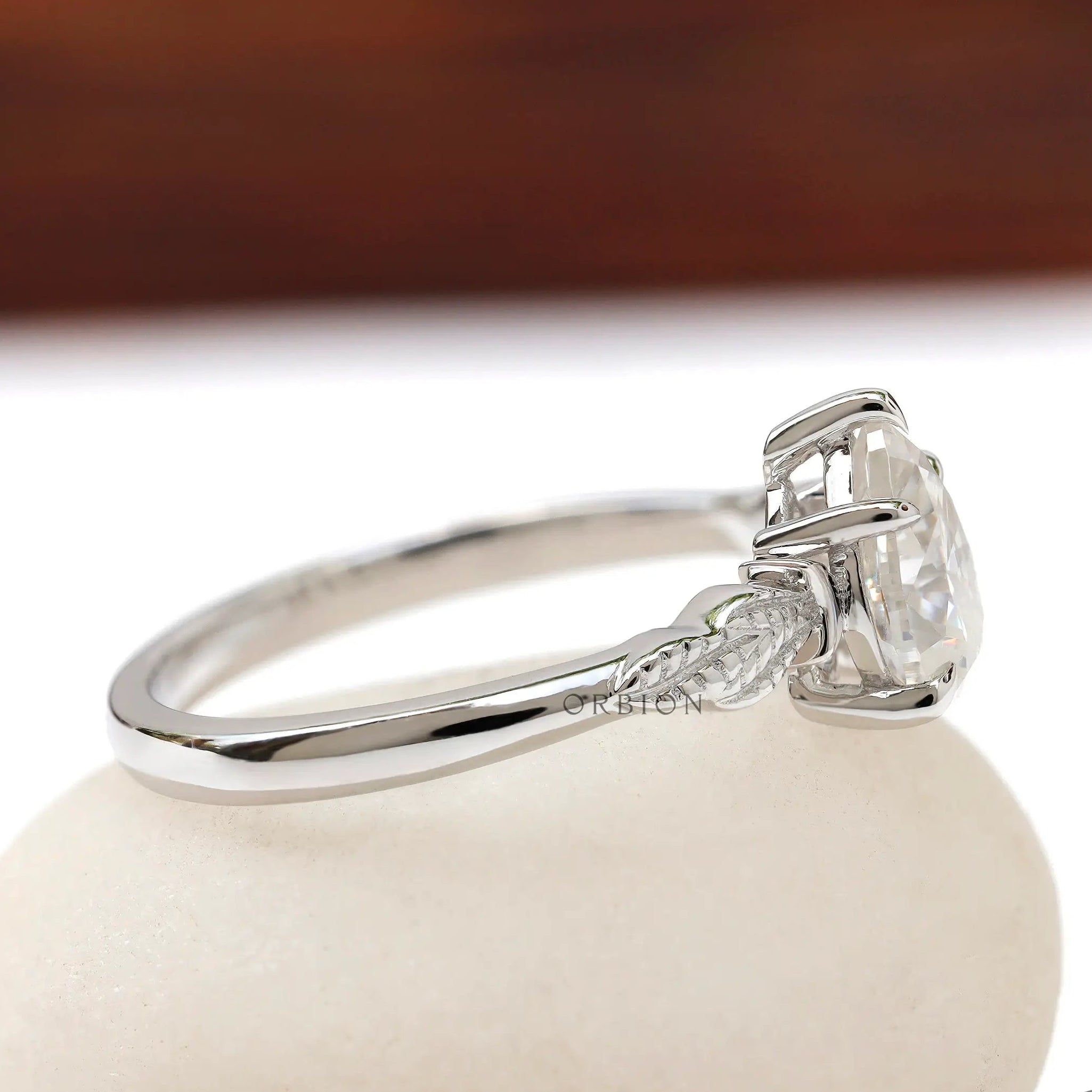 Siide angle of the white gold engagement ring with leaf detailing