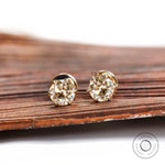 Front view light champagne moissanite stud earrings yellow gold
