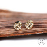 Front view light champagne moissanite stud earrings yellow gold