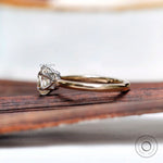 Side profile of elongated cushion moissanite solitaire ring in gold