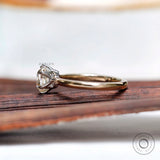 Side profile of elongated cushion moissanite solitaire ring in gold