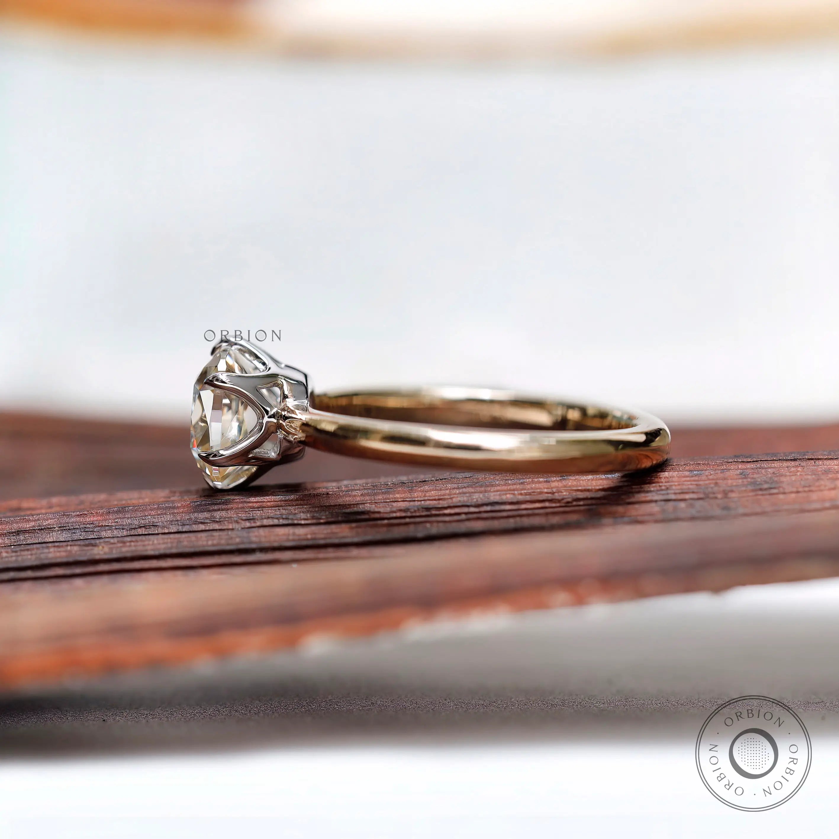 Side profile of elongated cushion moissanite solitaire ring in gold