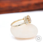 Side profile champagne moissanite three stone ring yellow gold