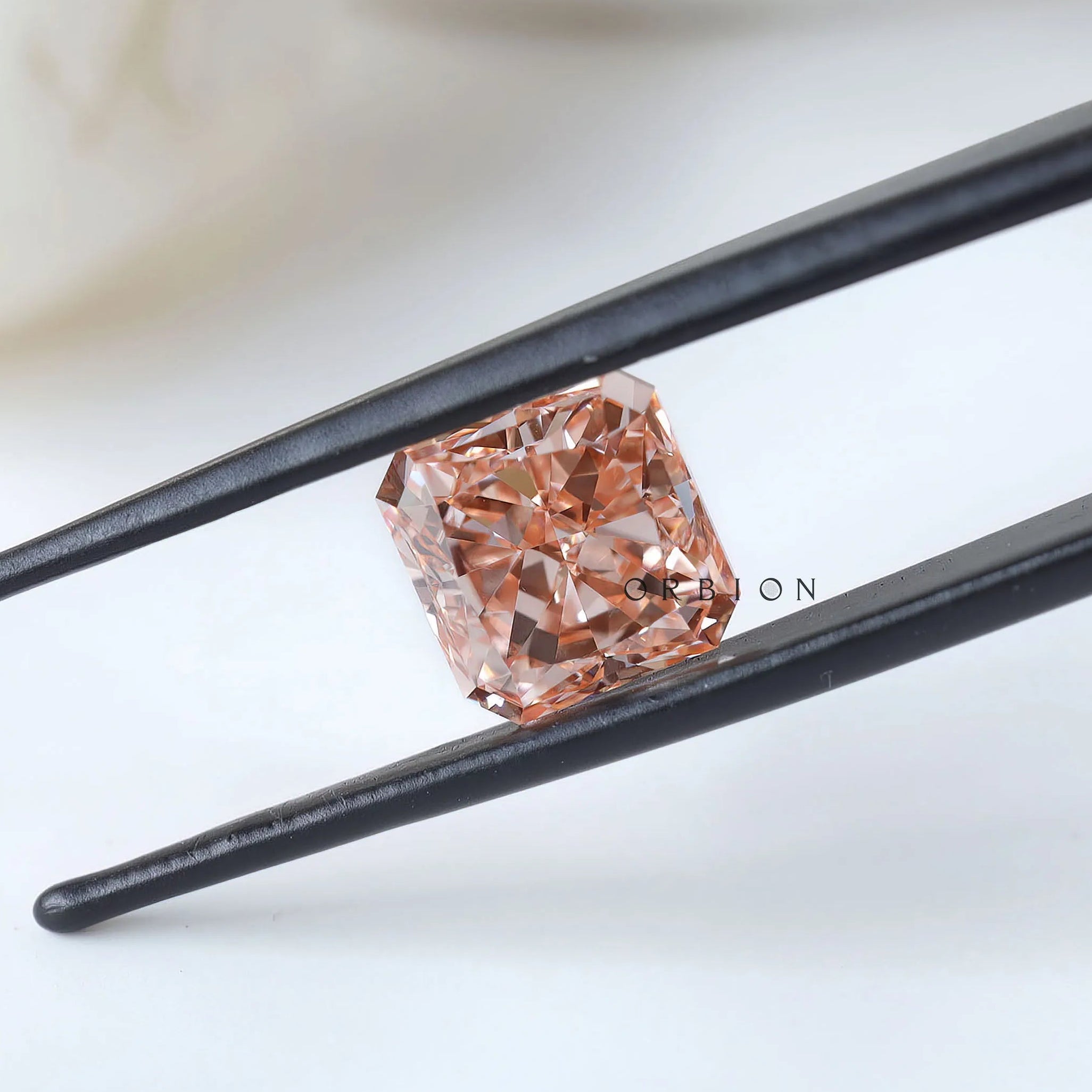 Side angled view of fancy vivid pink radiant diamond