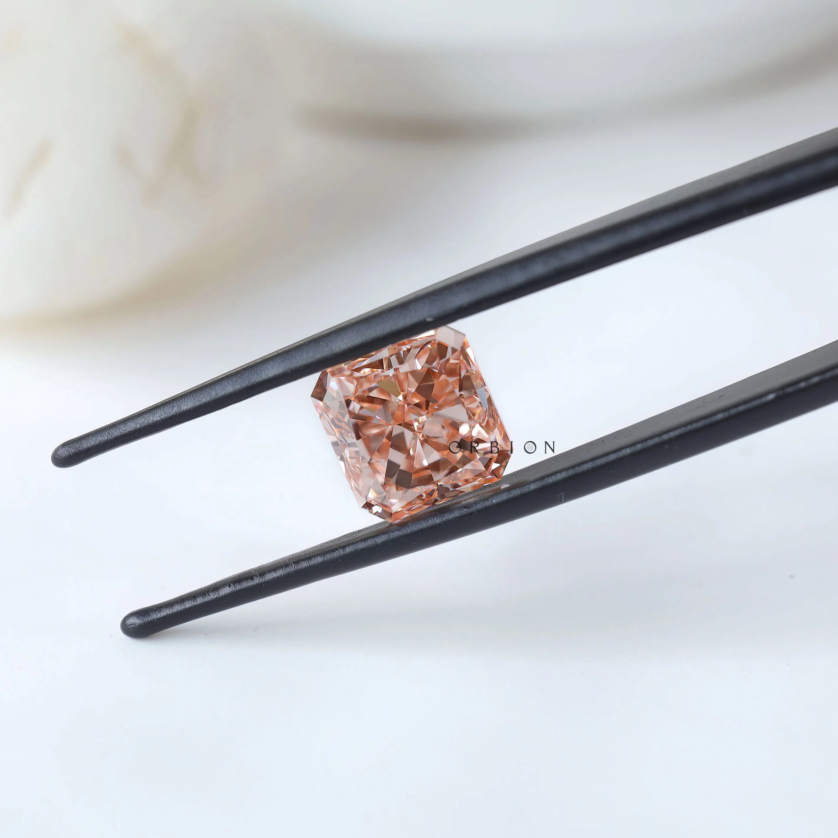 Side angled view of fancy vivid pink radiant diamond