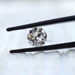 Vintage round moissanite with large facets in close view