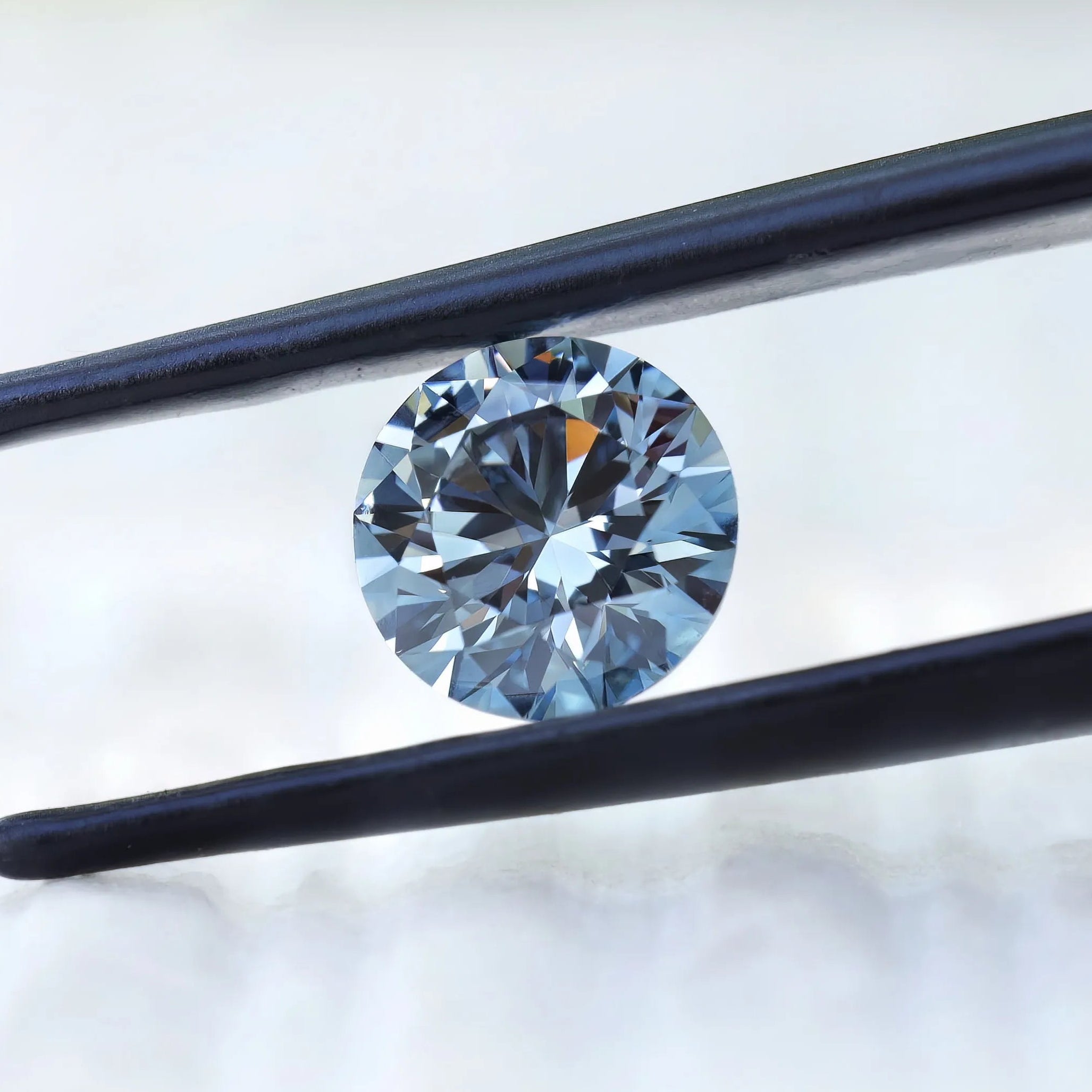 Side tilted view of fancy intense blue round diamond