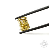 Brilliant cut radiant yellow lab diamond angled in tweezers