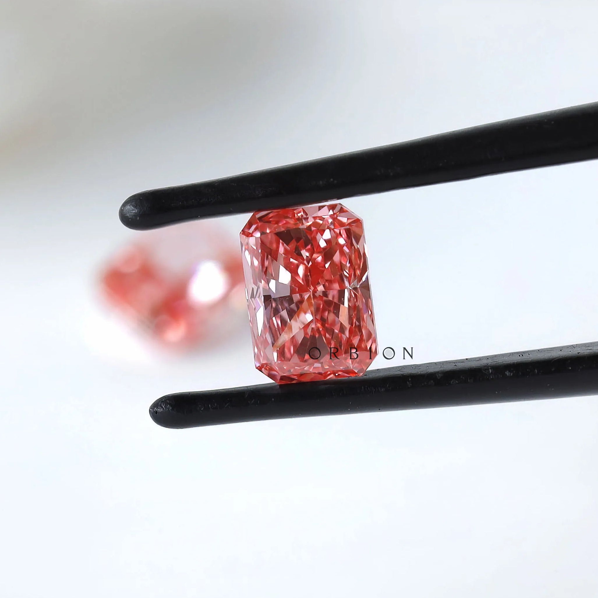 Angled radiant vivid pink loose diamond pair display