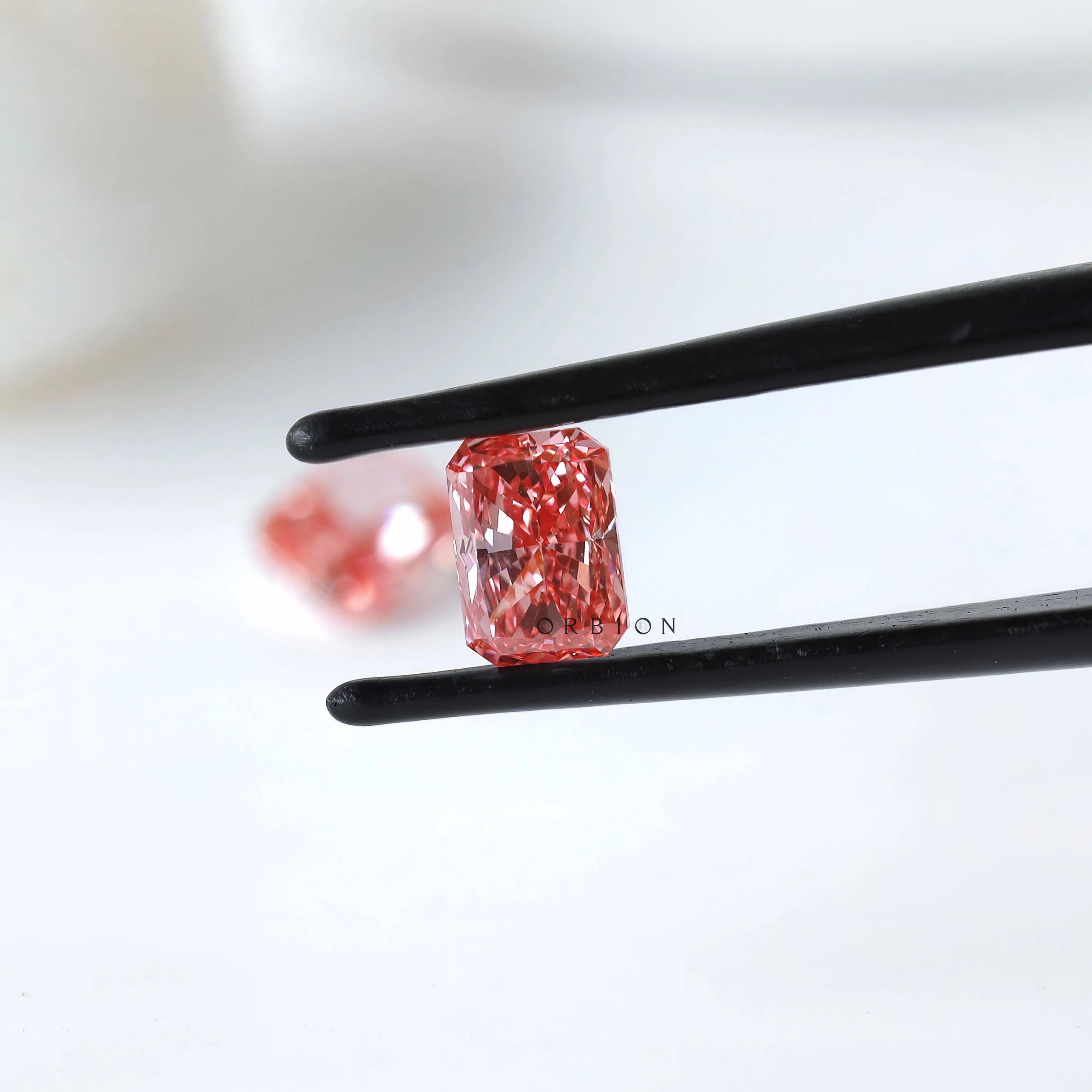 Angled radiant vivid pink loose diamond pair display