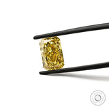 Bright yellow radiant lab diamond face up in tweezers