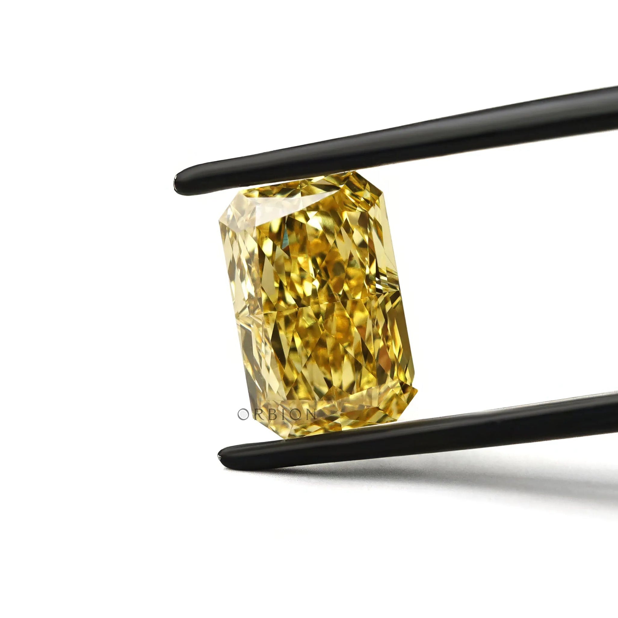 Bright yellow radiant lab diamond face up in tweezers