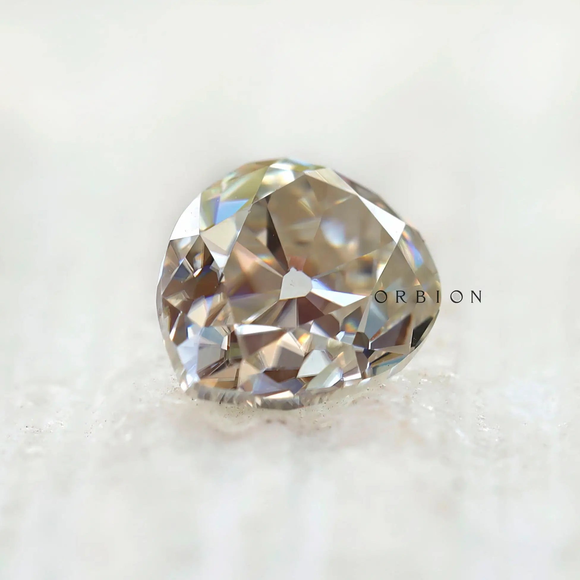 1.35 CT Old Mine Cut Moissanite Off White Pear Stone on display