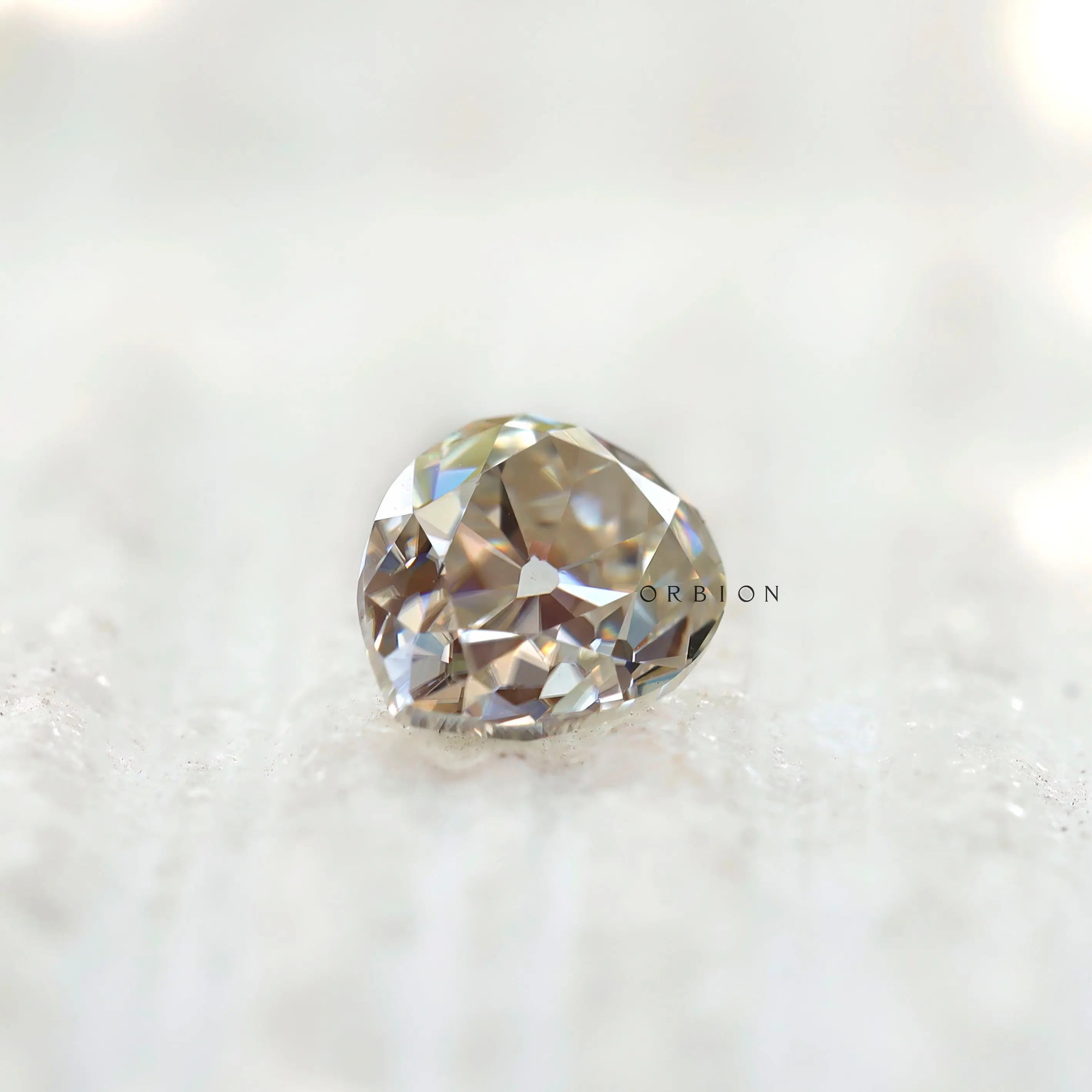 1.35 CT Old Mine Cut Moissanite Off White Pear Stone on display