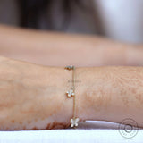 Worn top view minimal butterfly clover diamond bolo bracelet