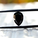 Side view of rose cut black pear moissanite