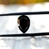 Side view of rose cut black pear moissanite