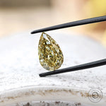 Close angled view of fancy yellow pear lab diamond