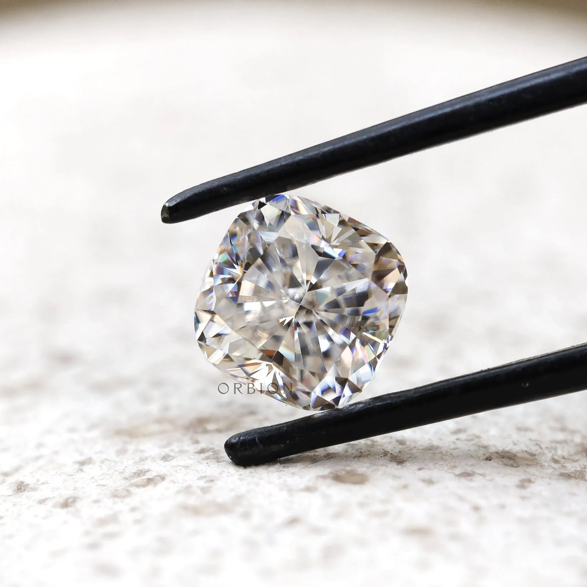 Side angled cushion moissanite with brilliant faceting detail