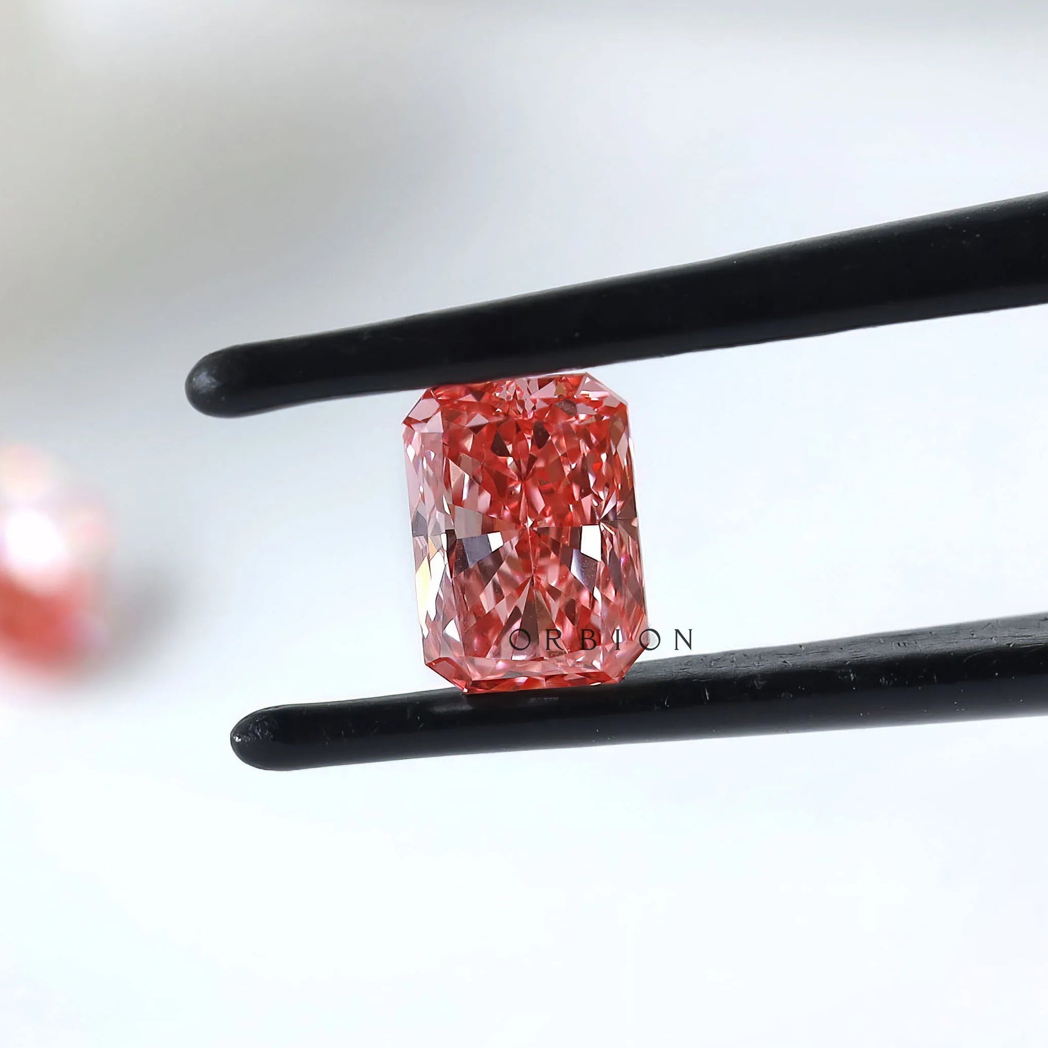 Side view of matching pink radiant lab diamond pair