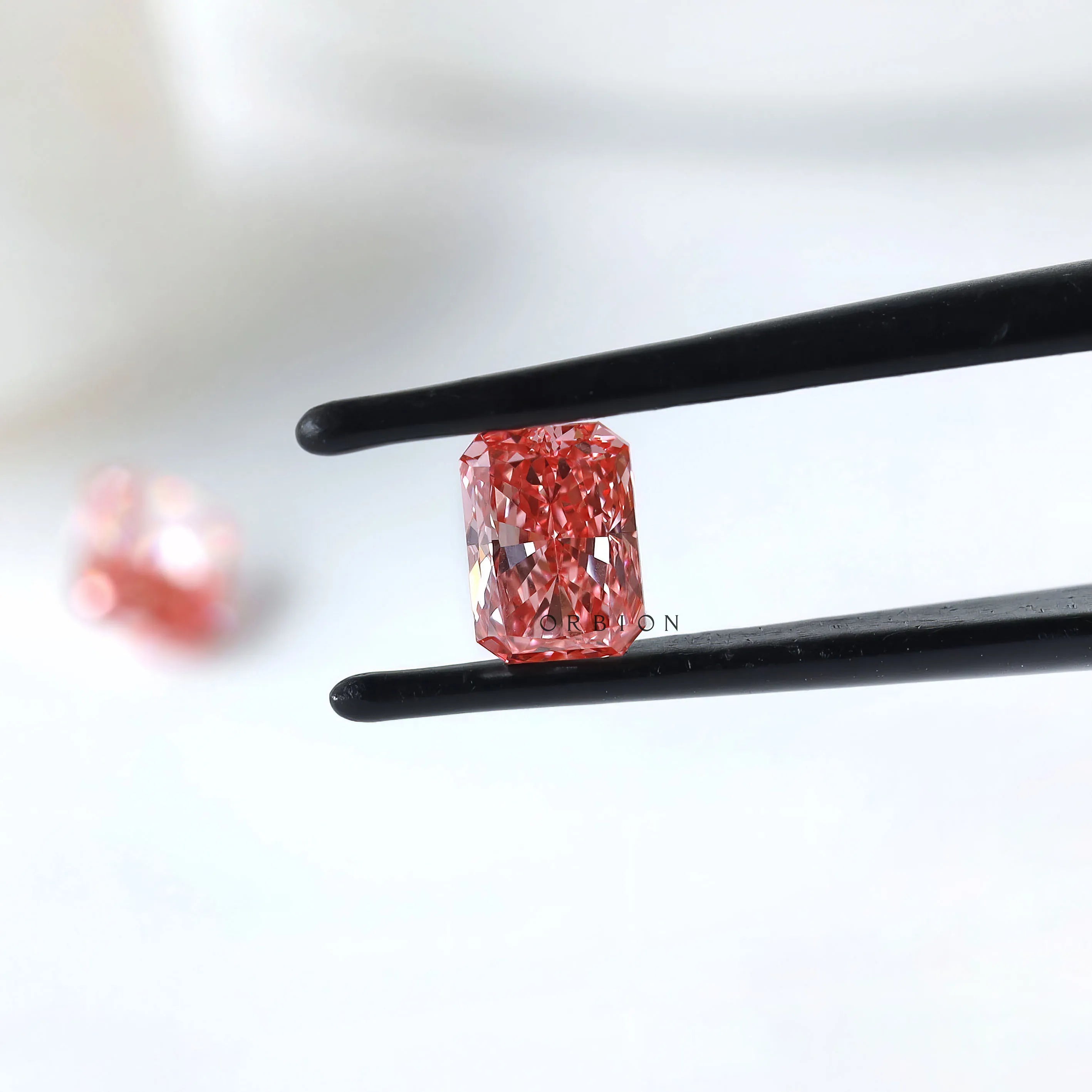 Side view of matching pink radiant lab diamond pair