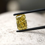 Fancy vivid yellow radiant diamond on textured surface