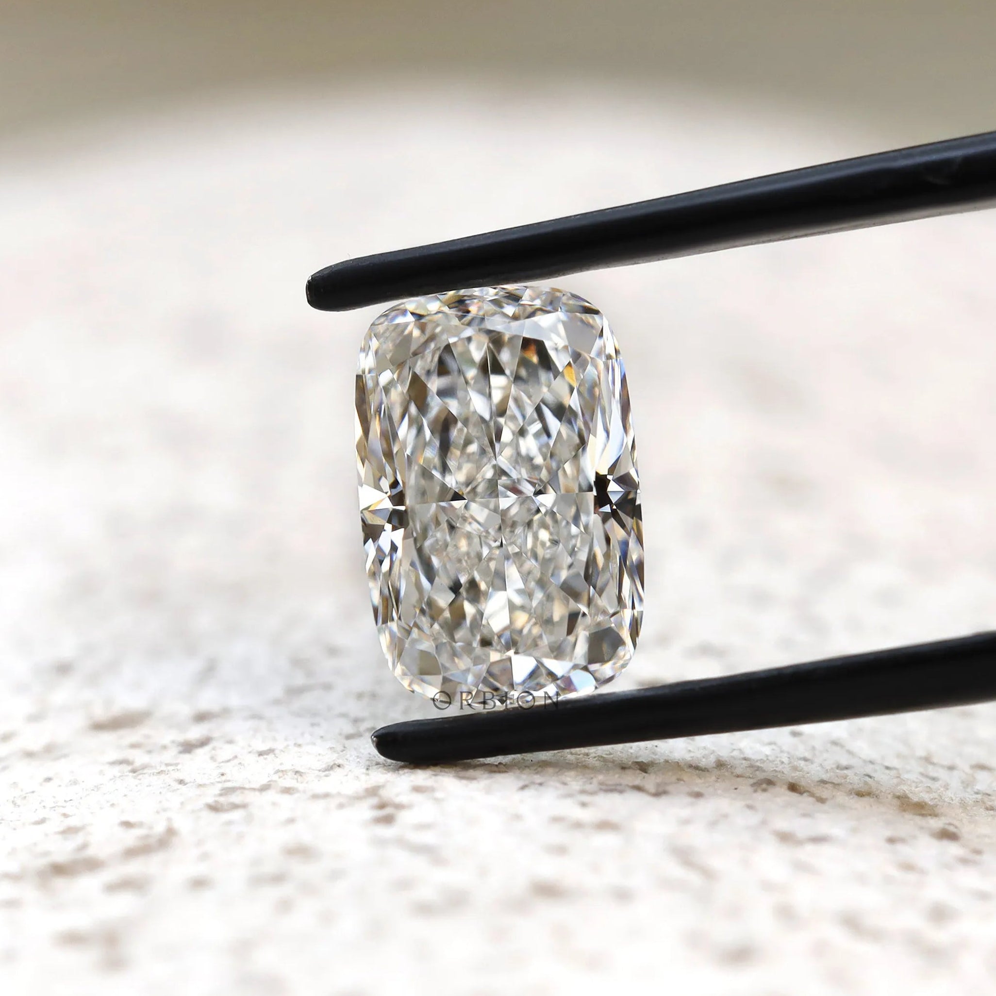 Front view elongated cushion loose lab diamond on light surface