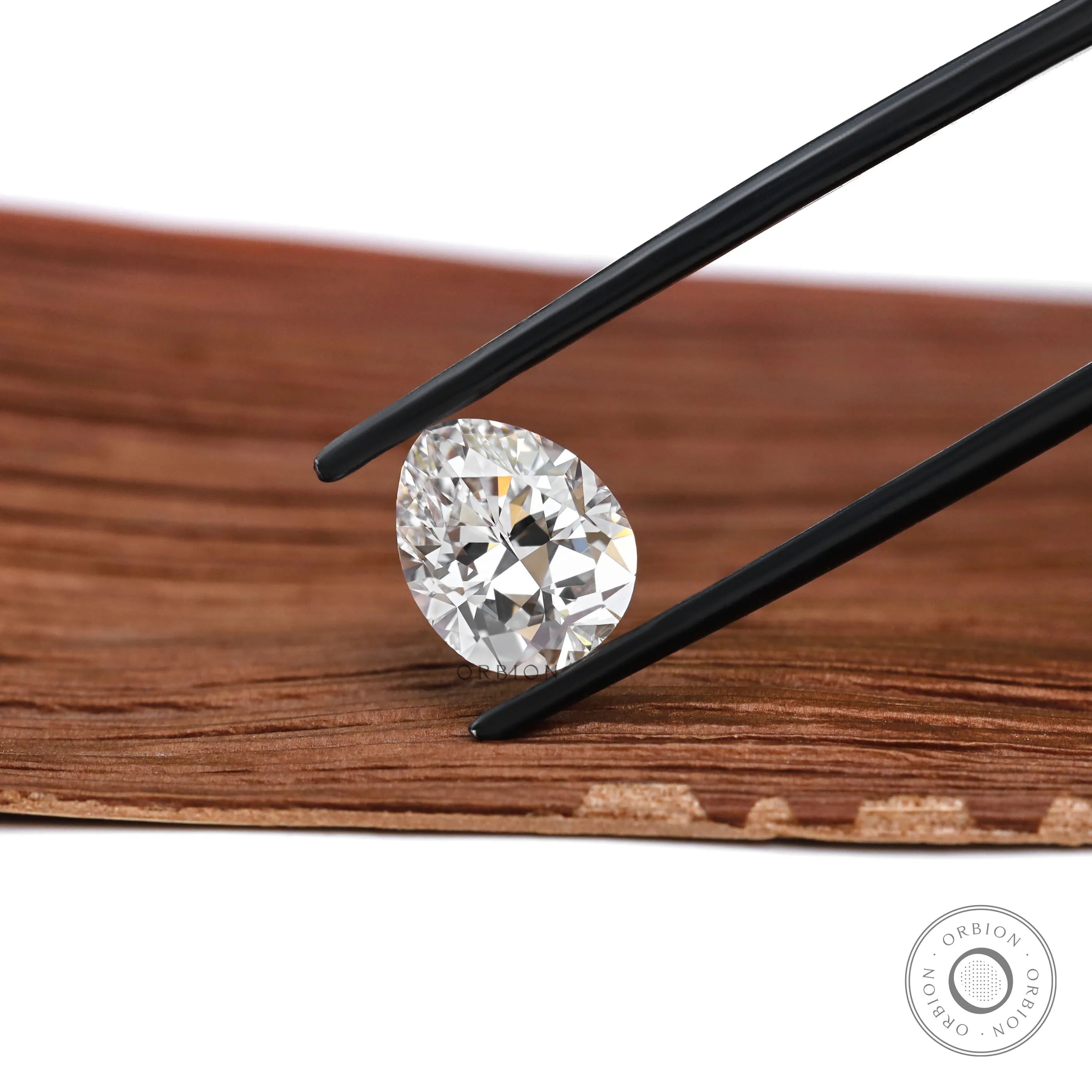 Pear brilliant cut loose diamond shown on neutral stone surface