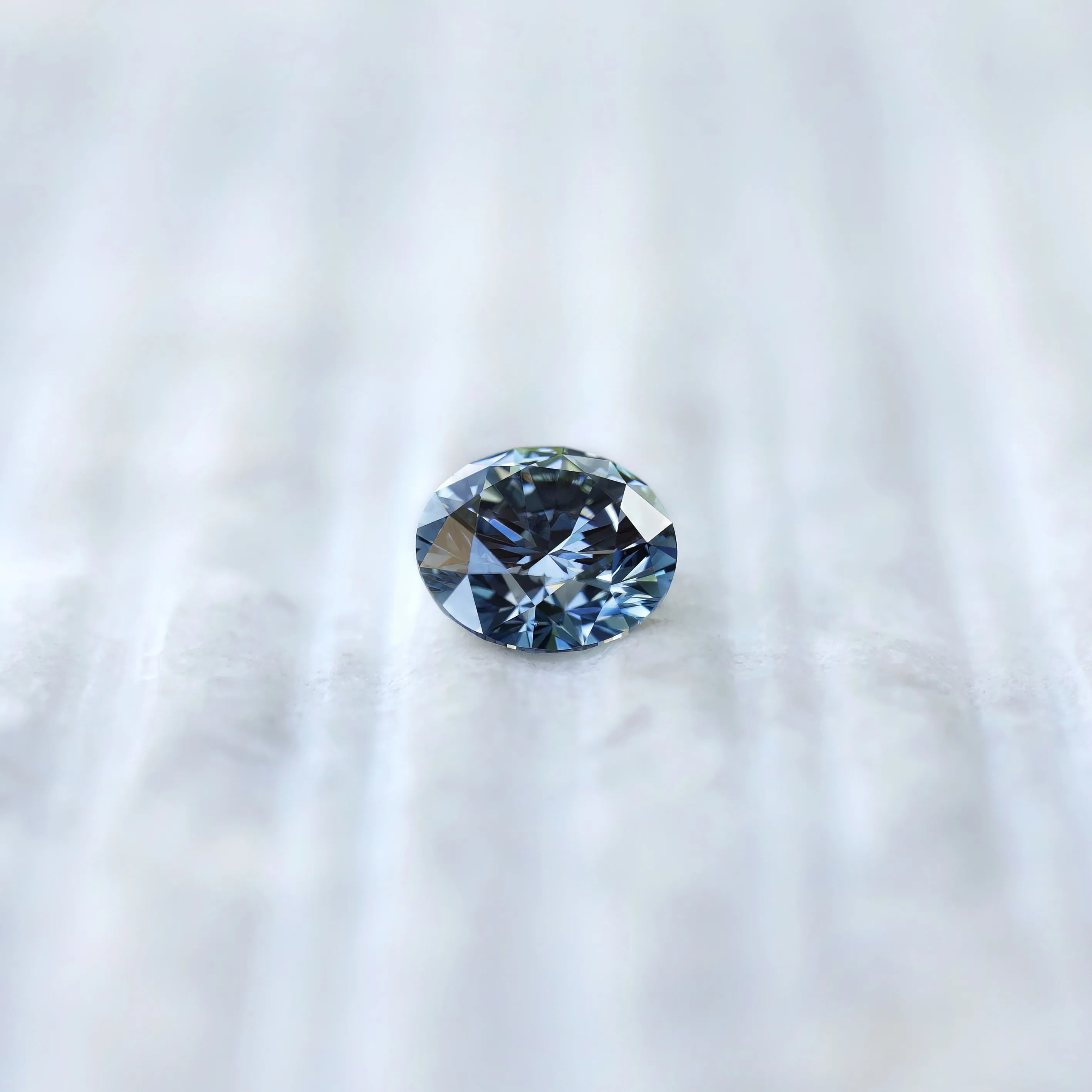 Face-up view of round brilliant intense blue lab diamond