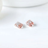 Close pavilion view of matching radiant pink diamond pair