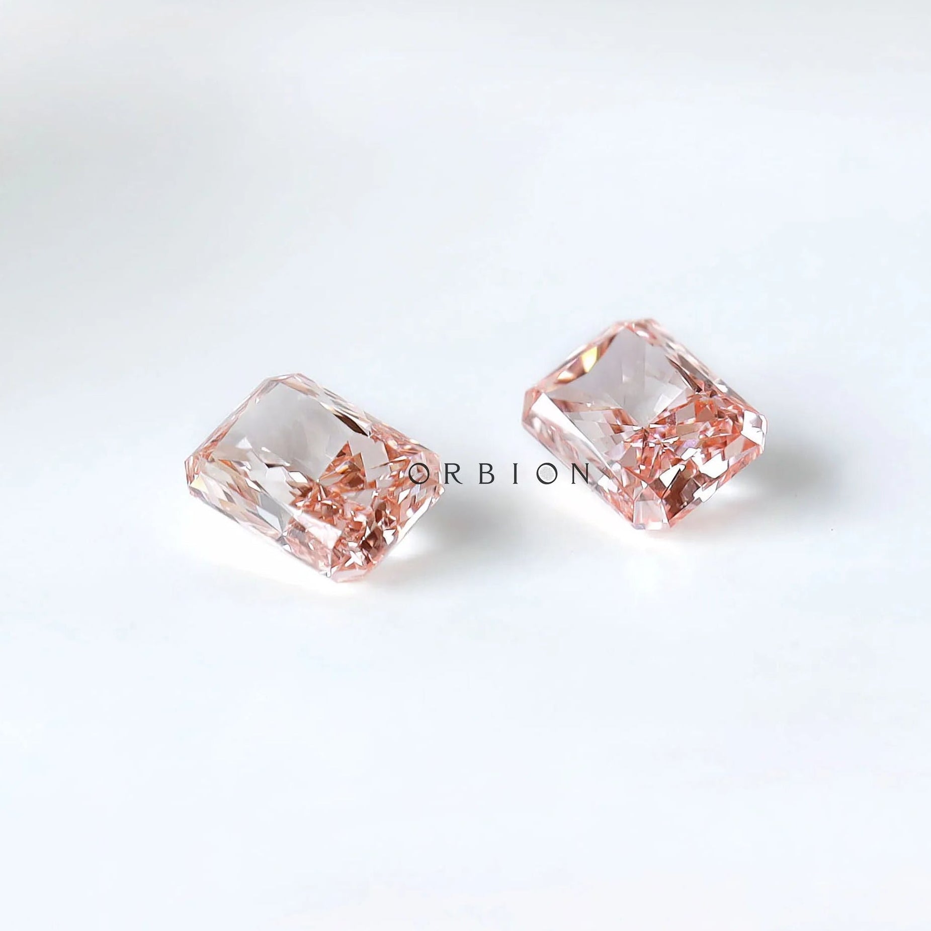 Close pavilion view of matching radiant pink diamond pair