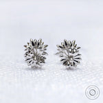 Lotus flower stud earrings featuring yellow diamond in white gold setting