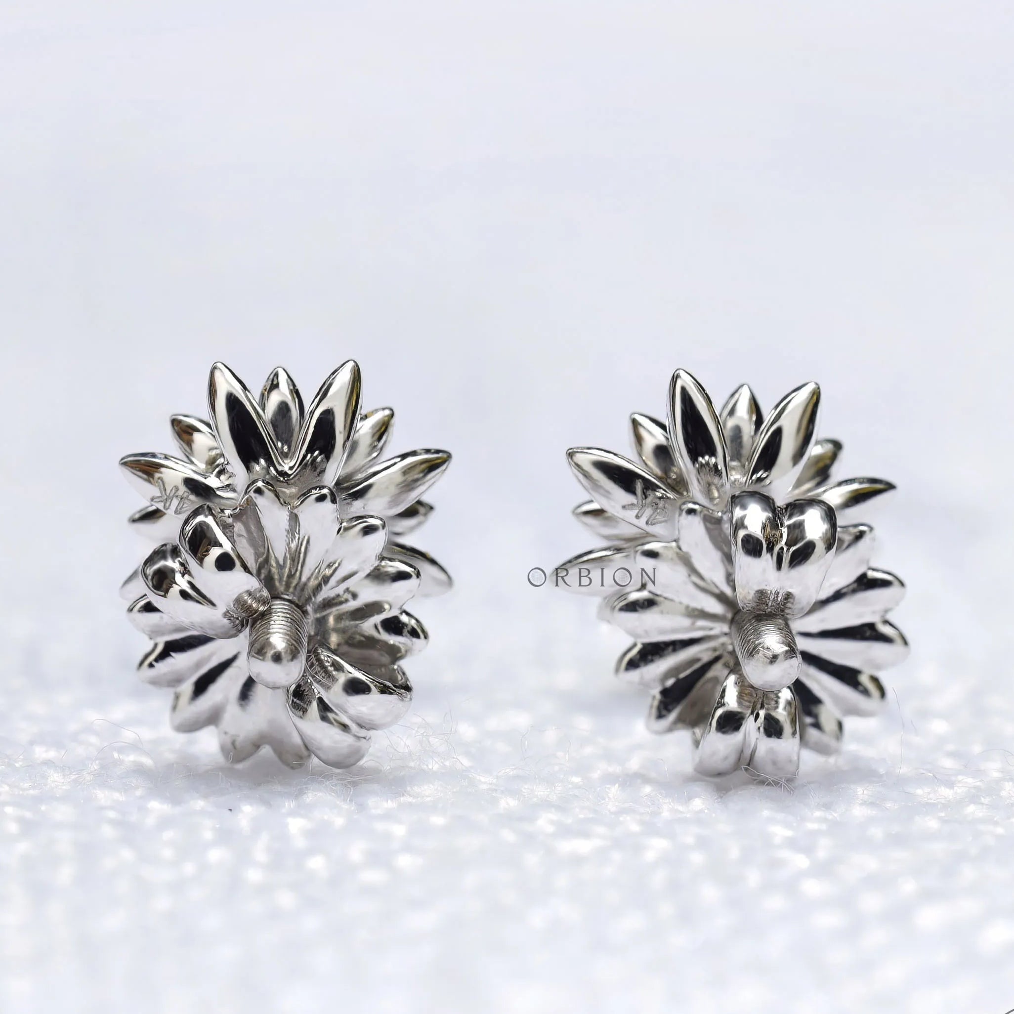 Lotus flower stud earrings featuring yellow diamond in white gold setting