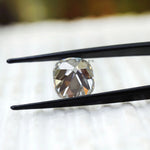 Vintage style cushion moissanite showing broad chunky faceting